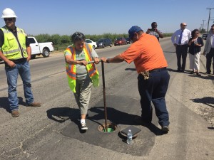 Matheny Tract Resident Reyna Palma opens the water valve to signify bringing clean, reliable drinking water to the community.