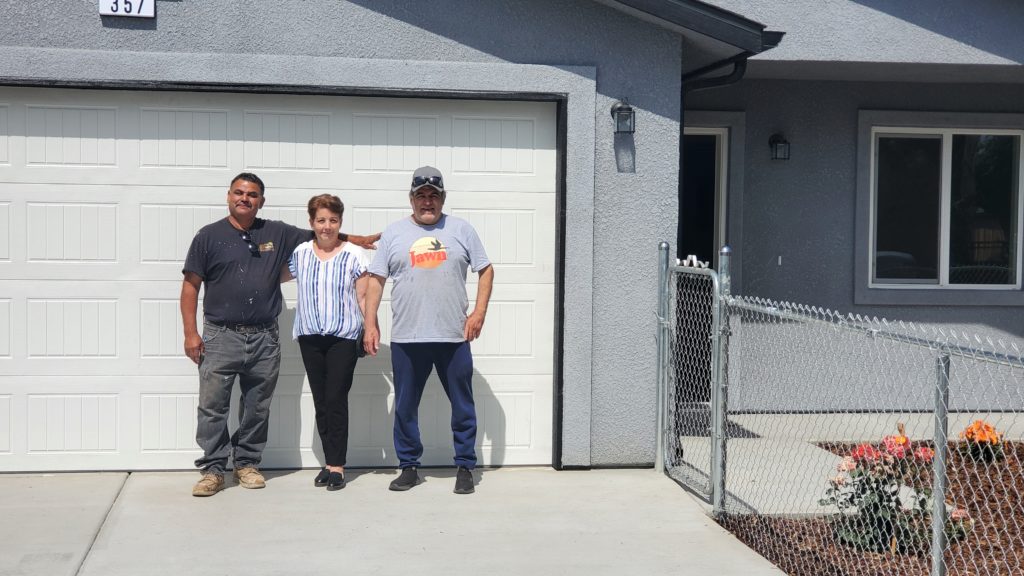 The Castellanos Family stands proudly in front of their new driveway with contractor, Tony Gonzalez