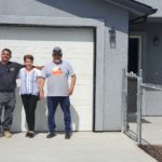 The Castellanos Family stands proudly in front of their new driveway with contractor, Tony Gonzalez